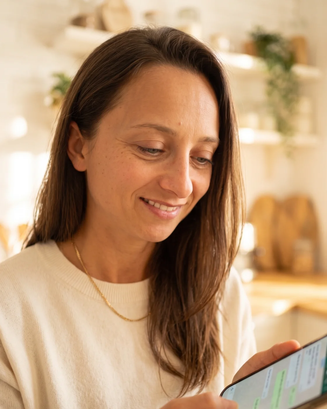 A parent holding a phone showing the day's Daily Spark game